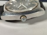 a close up of a watch on a white surface
