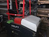 a picture of a forklift in a warehouse with pallets