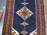 an image of a blue rug with a diamond design on top of it
