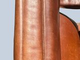 a brown leather chair with a brown seat and arm rest
