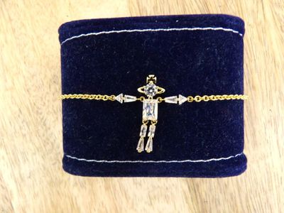 a small blue velvet box with a gold cross on it