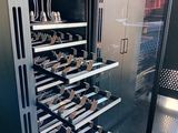 an image of a wine cooler with many bottles in it