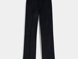 a pair of black pants on a hanger against a white wall
