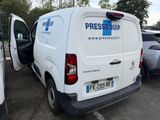 a white van parked in a parking lot with its door open