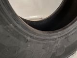 a close up of a tire on a white wall with a white background