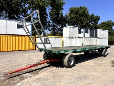 a trailer with a ladder attached to it in a parking lot