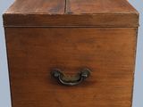 an old wooden box with a metal handle on a gray background