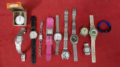 a lot of watches that are sitting on a red surface