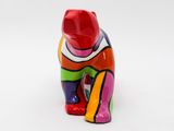 a colorful cat figurine sitting on a white surface