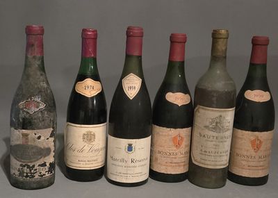 several bottles of wine are lined up in a row on a table