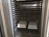 an image of an open oven with two trays of food in it