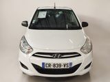 a white car that is parked in a room