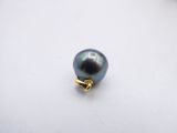 a close up of a black pearl on a white surface