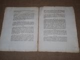 two pages of a book on a brown surface
