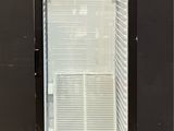 an image of a glass door refrigerator in a room