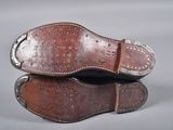 pair of brown leather shoes with rivets and studs on them