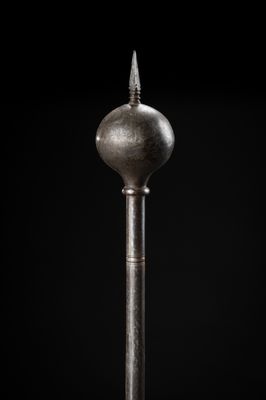 a close up of a metal object on a black background