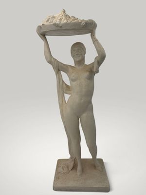 statue of a woman holding a tray of food on her head