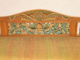 a wooden bench with carvings on it in a room