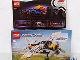 two boxes of lego technics sitting on a table