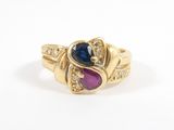 a close up of a gold ring with a blue and pink stone