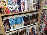 a book shelf full of dvds and movies in a room