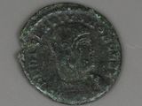 a close up of a coin with a face on it