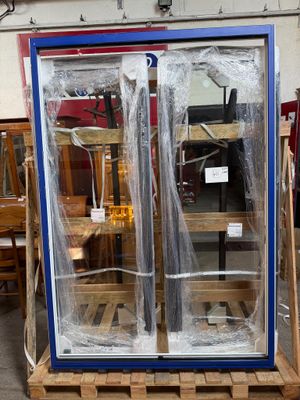 une vitrine posée sur une palette dans un entrepôt