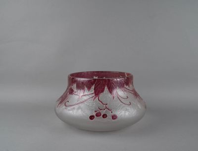 a small glass vase with a red design on it
