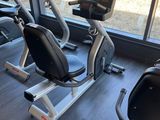 a row of stationary exercise bikes in a gym