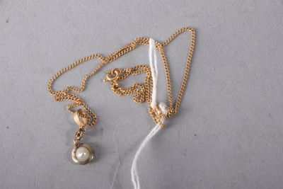 necklace with a pearl and a gold chain on a white background