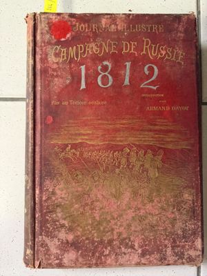 un vieux livre sur lequel figure une image de chevaux