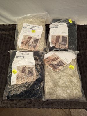 three bags of blankets are sitting on a blanket on a bed