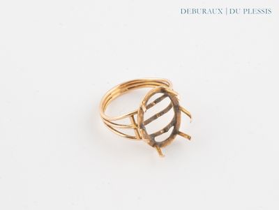 an image of a gold ring on a white surface with a black and white stripe