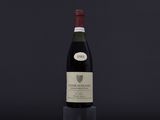 the bottle of wine is sitting on a black table