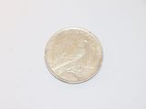 an image of a small coin on a white surface