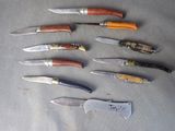 several different types of knives are lined up on a table
