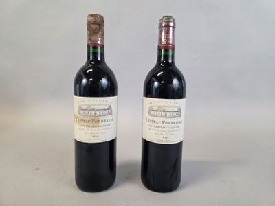 two bottles of wine sitting next to each other on a table