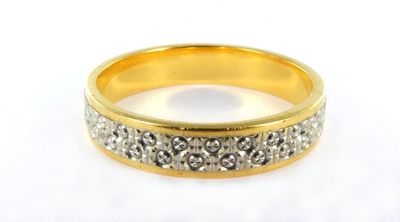 a close up of a ring with diamonds on a white surface
