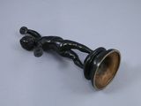 a small black candle holder on a white table