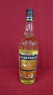 a close up of a bottle of whisky on a red surface