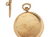 an image of a gold pocket watch with a key on a white background