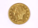 a close up of a gold coin on a white surface