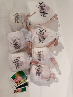 five bags of toilet paper with the names of the bride and groom on them