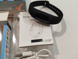 a box with a wristband and a charger on it