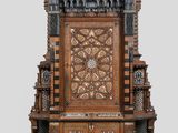 a wooden throne with a clock on top of it