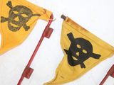 yellow and black pirate flag with skull and crossbones on it