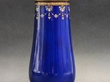 an antique blue vase with gold trimming and a lid