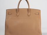 a tan leather tote bag on a white background