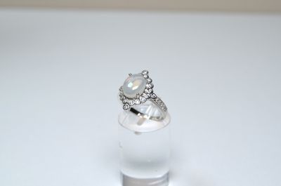 an image of a diamond ring sitting on top of a clear glass